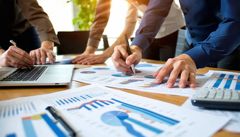 Professional business consultants working on financial reports at River Rock SBC